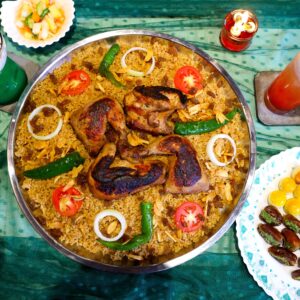 Rich display of Indonesian cuisine, showcasing traditional grilling and vibrant beverages.